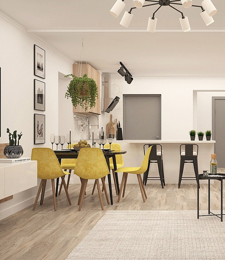 Jasny salon połączony z kuchnią i jadalnią z żółtymi krzesłami